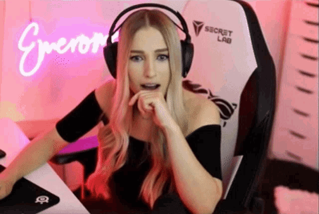 a woman wearing headphones and a secret lab chair