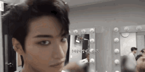 a close up of a person 's face in front of a mirror .