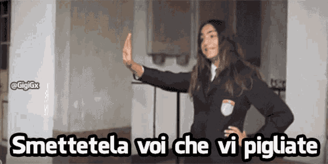a woman in a suit giving the middle finger with the words smettetela voi che vi pigiate below her