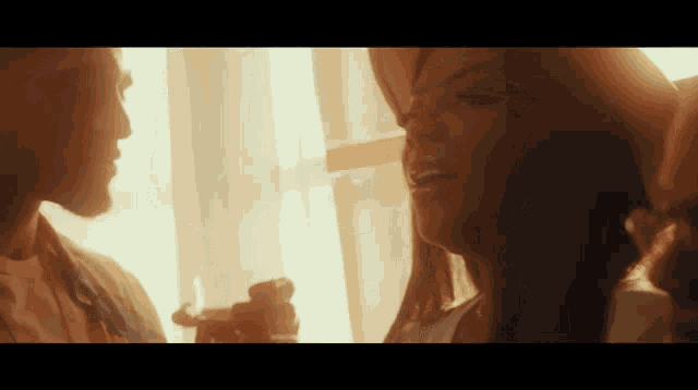 a man and a woman are looking at each other