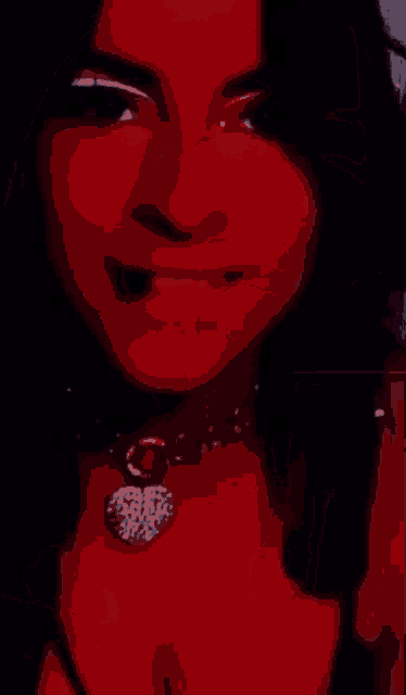a close up of a woman wearing a necklace and lipstick