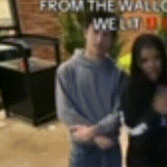 a blurry picture of a man and a woman standing in front of a sign that says from the wall welt