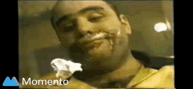 a man with shaving cream on his face and the words momento on the bottom