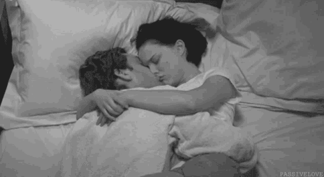 a black and white photo of a couple sleeping with the caption passivelove
