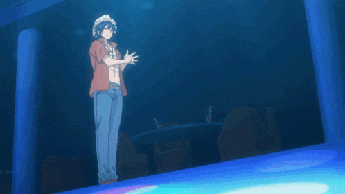a man in a white hat is standing on a blue stage