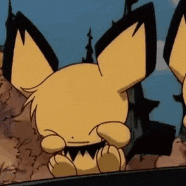 a close up of a cartoon character with big ears sitting on a table .