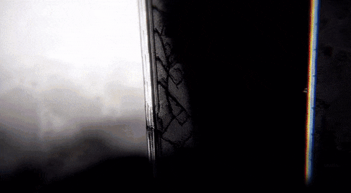a black and white photo of a door with graffiti on it that says " x "
