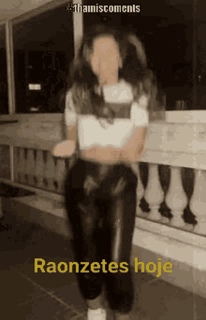 a woman in a white shirt and black pants is dancing with the words raonzetes hoje on the bottom .