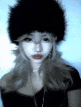 a blurry picture of a woman wearing a black hat