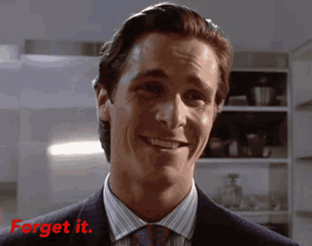 a man in a suit and tie is smiling with the words " forget it " below him