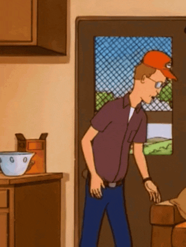 a man in a purple shirt and an orange hat is standing in front of a door