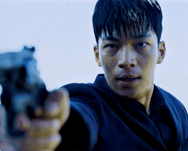 a man is pointing a gun at the camera with a white background