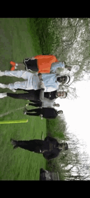 a group of people are posing for a picture in a field