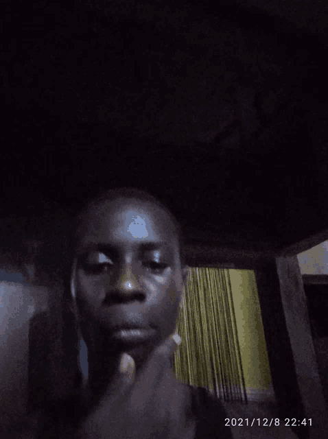 a man 's face is shown in a photo taken on december 8th 2021
