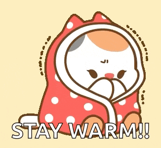 a cartoon cat wrapped in a blanket with the words `` stay warm '' written on it .