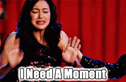 a woman is being held by a man with the words " i need a moment " below her