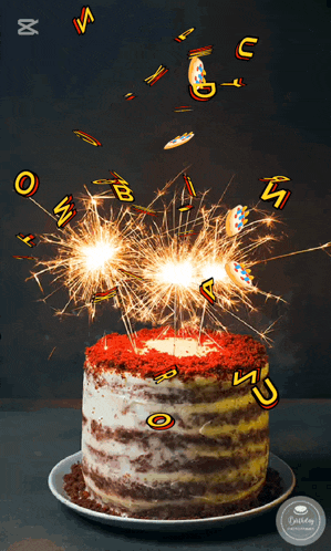 a birthday cake with sparklers and letters coming out of the top