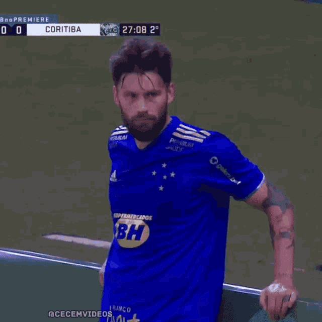 a man in a blue shirt with bh on the front