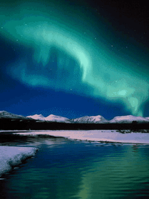 the aurora borealis shines brightly over a frozen lake