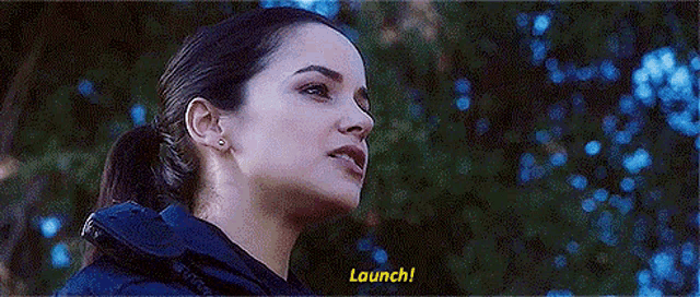 a close up of a woman 's face with the words `` launch '' written in yellow .