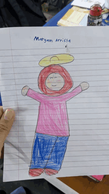 a child 's drawing of a girl with the name maryam written at the top