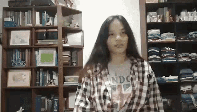 a girl wearing a plaid shirt that says london on it