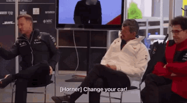 a group of men are sitting in front of a tv and one of them says horner change your car