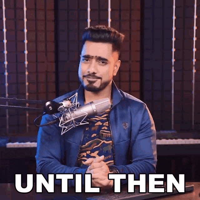 a man sitting in front of a microphone with the words until then written below him