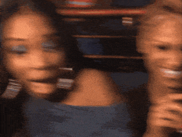 a blurry picture of a woman 's face and another woman 's face