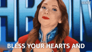 a woman says bless your hearts and is wearing a red shirt