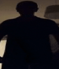 a silhouette of a person in a dark room .