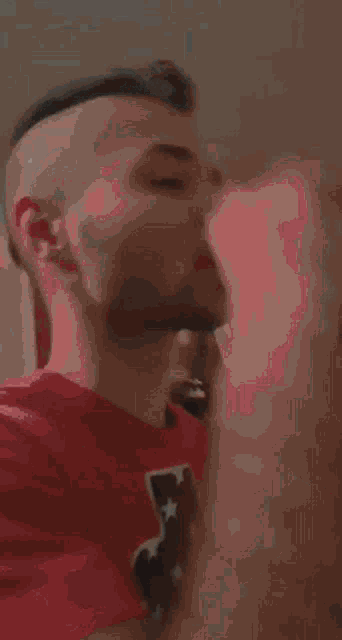 a man with a beard is drinking from a bottle of water