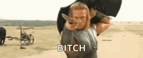a man is carrying a bag on his back in the desert and says `` bitch '' .