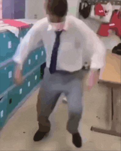 a man in a white shirt and tie is dancing