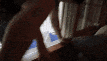 a blurry picture of a person standing on a bed