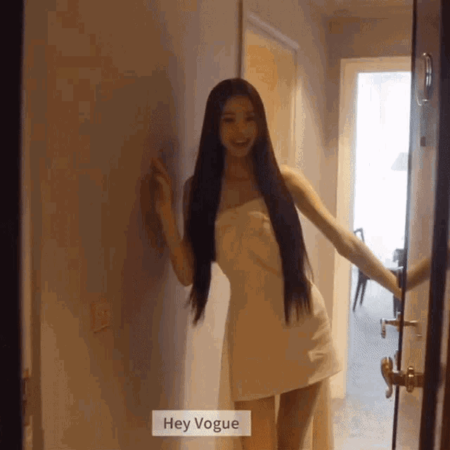 a woman wrapped in a white towel with the words hey vogue on the bottom right
