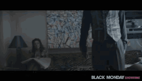 a woman sits on a couch while a man stands in front of her with the words it 's black monday showtime
