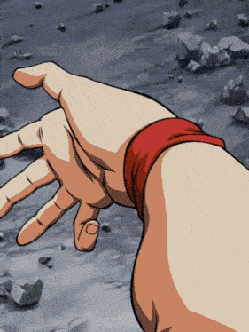 a hand with a red band around the wrist