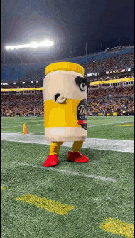 a mascot dressed as a jar of mustard is on a football field