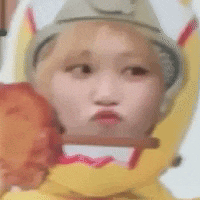 a close up of a person wearing a banana hat and holding a banana