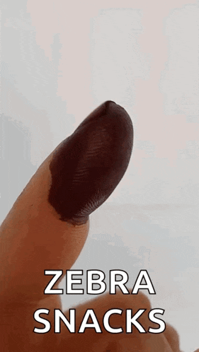 a close up of a finger with the words zebra snacks on it