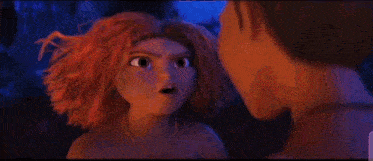 a man and a woman are standing next to each other in the dark .