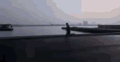 a blurry picture of a person walking near a body of water .