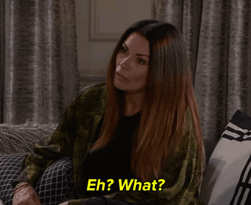 a woman sitting on a couch with the words eh ? what behind her