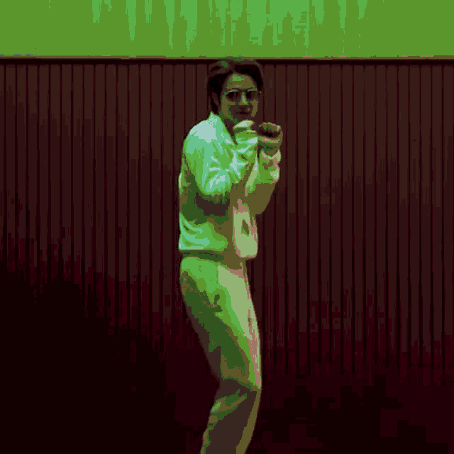 a pixelated image of a man standing in front of a wall
