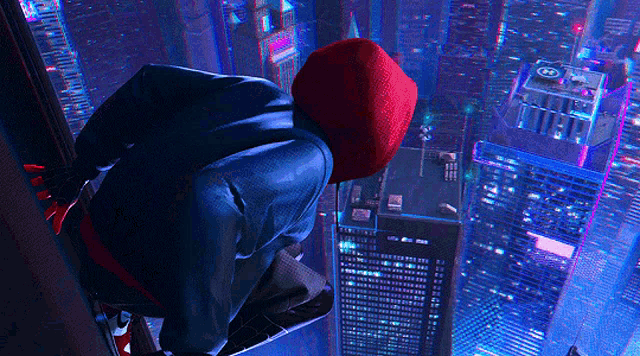 a man in a spiderman costume looks out over a city