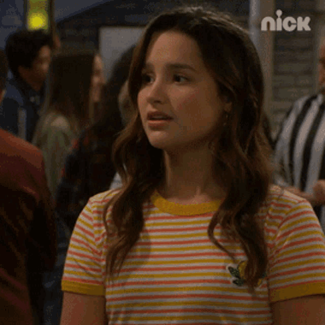 a woman is wearing a striped shirt with a frog on it