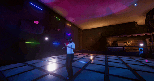 a man is standing on a dance floor in a dark room with neon lights