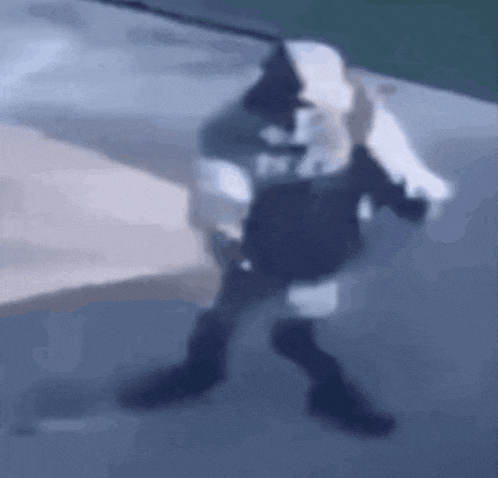 a blurry picture of a person walking down a street .