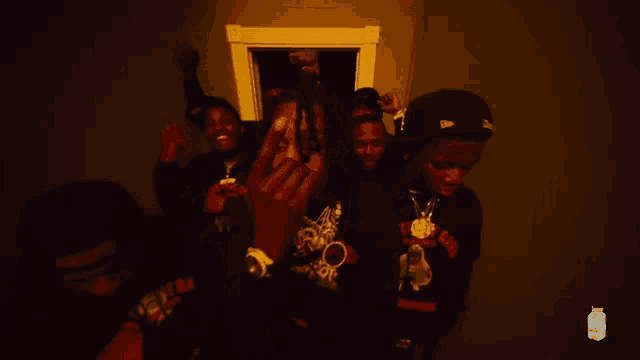 a group of young men are standing in a dark hallway with a bottle of milky way in the background